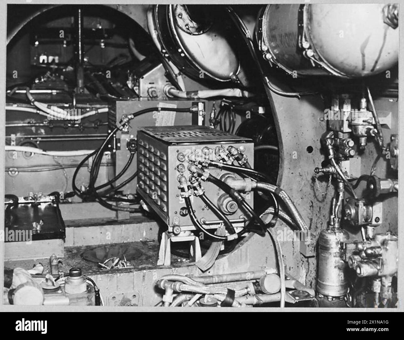 RADAR EQUIPMENT IN MOSQUITO NIGHT FIGHTERS - The Lucerno unit in the Mosquito night fighter is fitted inside the fuselage, about level with the trailing edge of the main plane. The equipment is controlled by switches on the main indicator. The IFF Mk.III receiver is visible just behind the Lucerno box, Royal Air Force Stock Photo