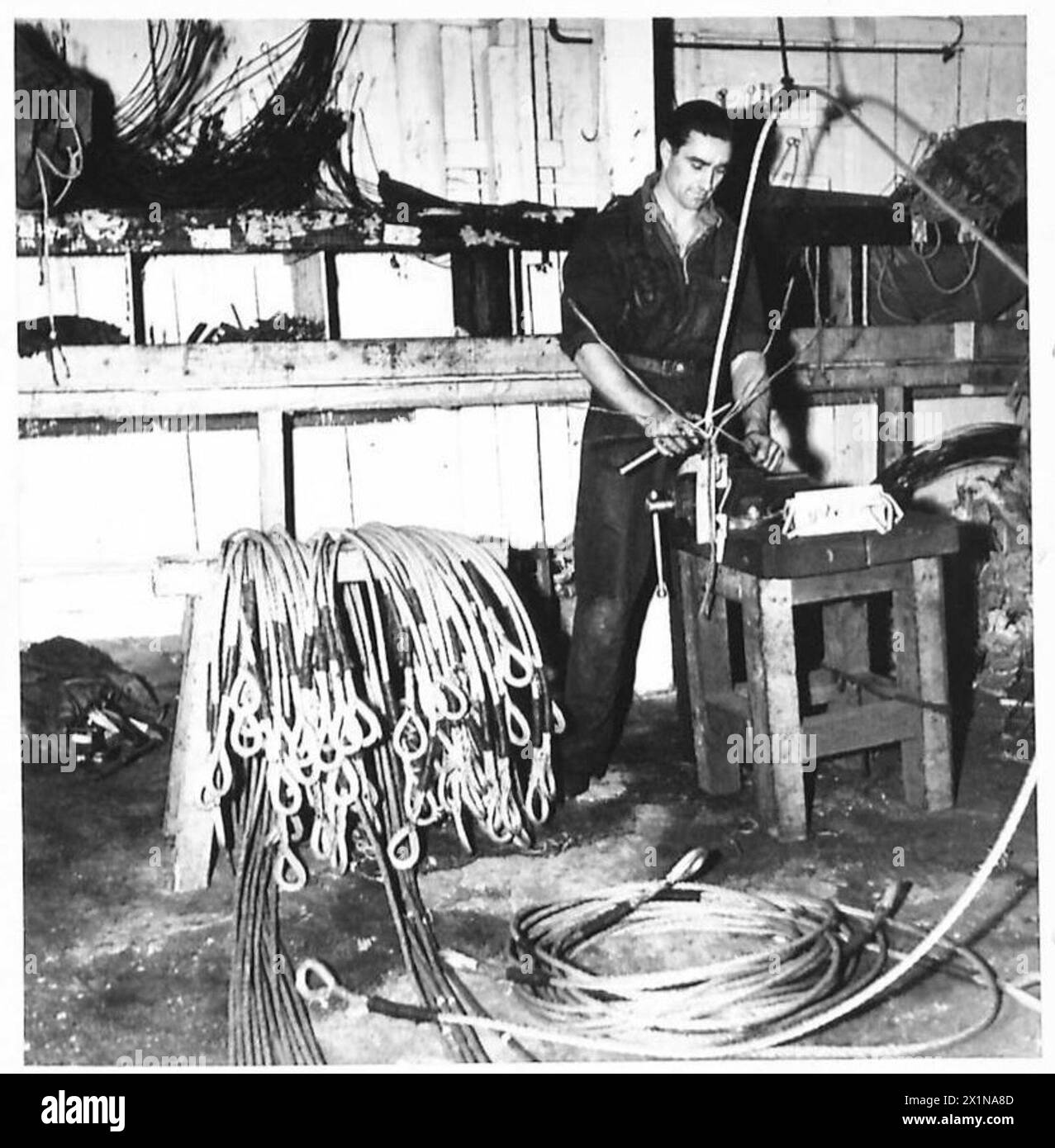 British Army personnel perform a special assignment splicing boom wires ...