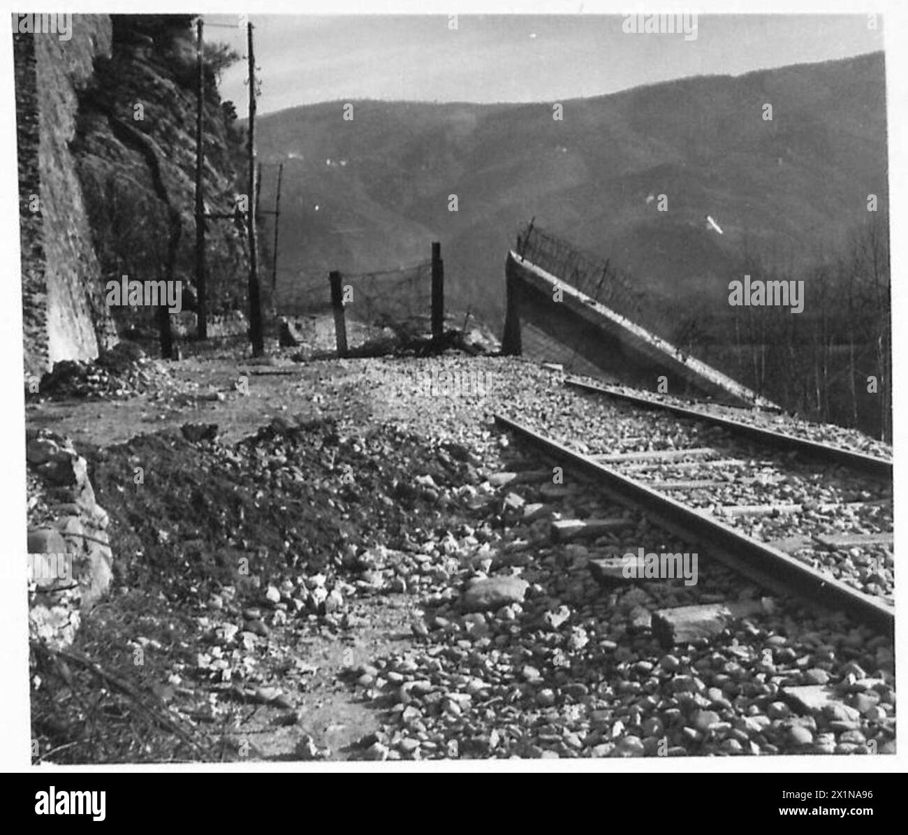 FIFTH ARMY : THE SERCHIO VALLEY - The concrete Gothic Line ends across the Valley at the mountainside. Picture shows part of the concrete wall next to the railway line through the valley, British Army Stock Photo