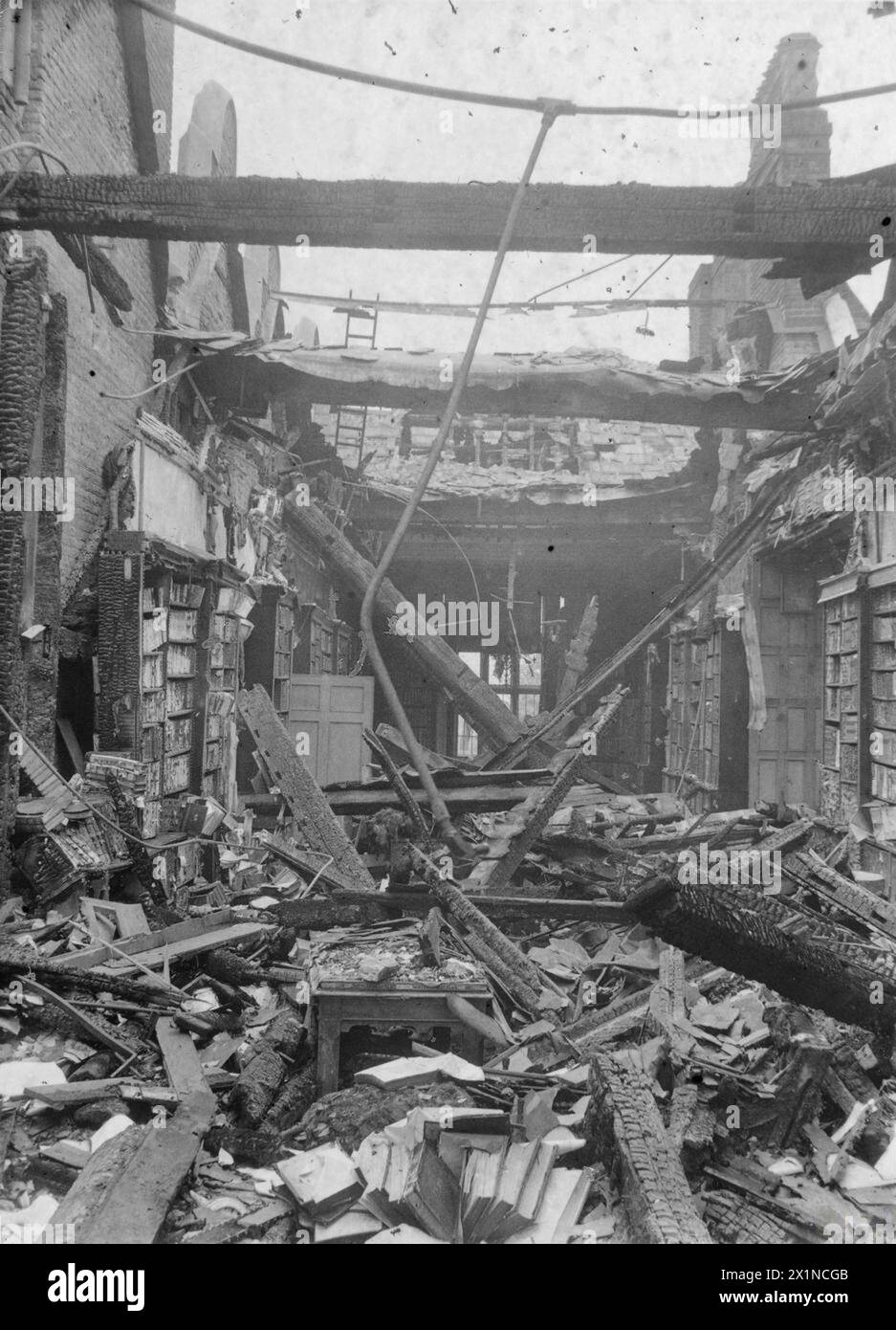 Black-and-white photograph showing extensive bomb damage inside a ...