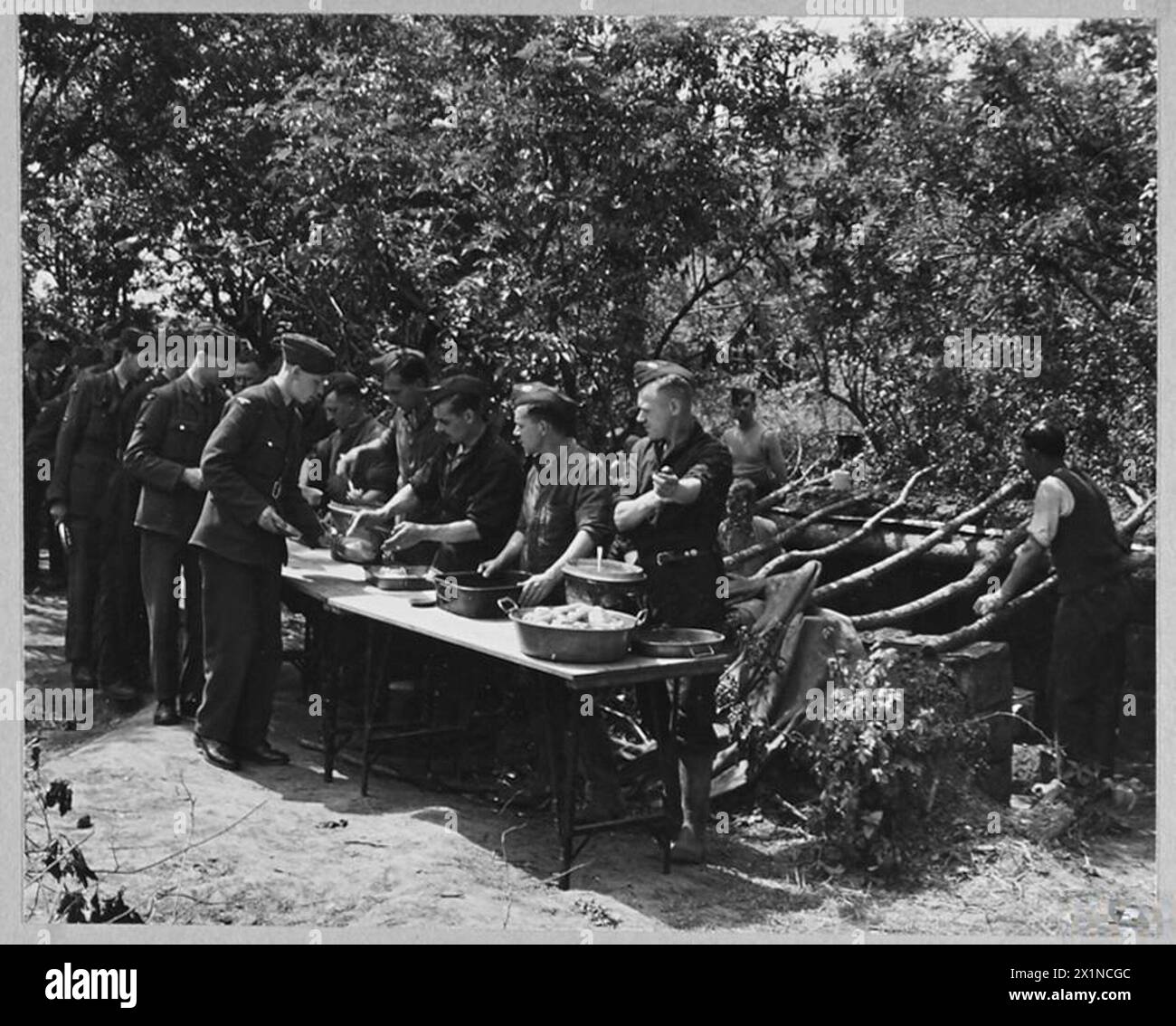 R.A.F's NEW SAFETY METHOD OF FIELD COOKING - 10488 Picture (issued 1943) shows - Airmen queueing up for their meal, Royal Air Force Stock Photo