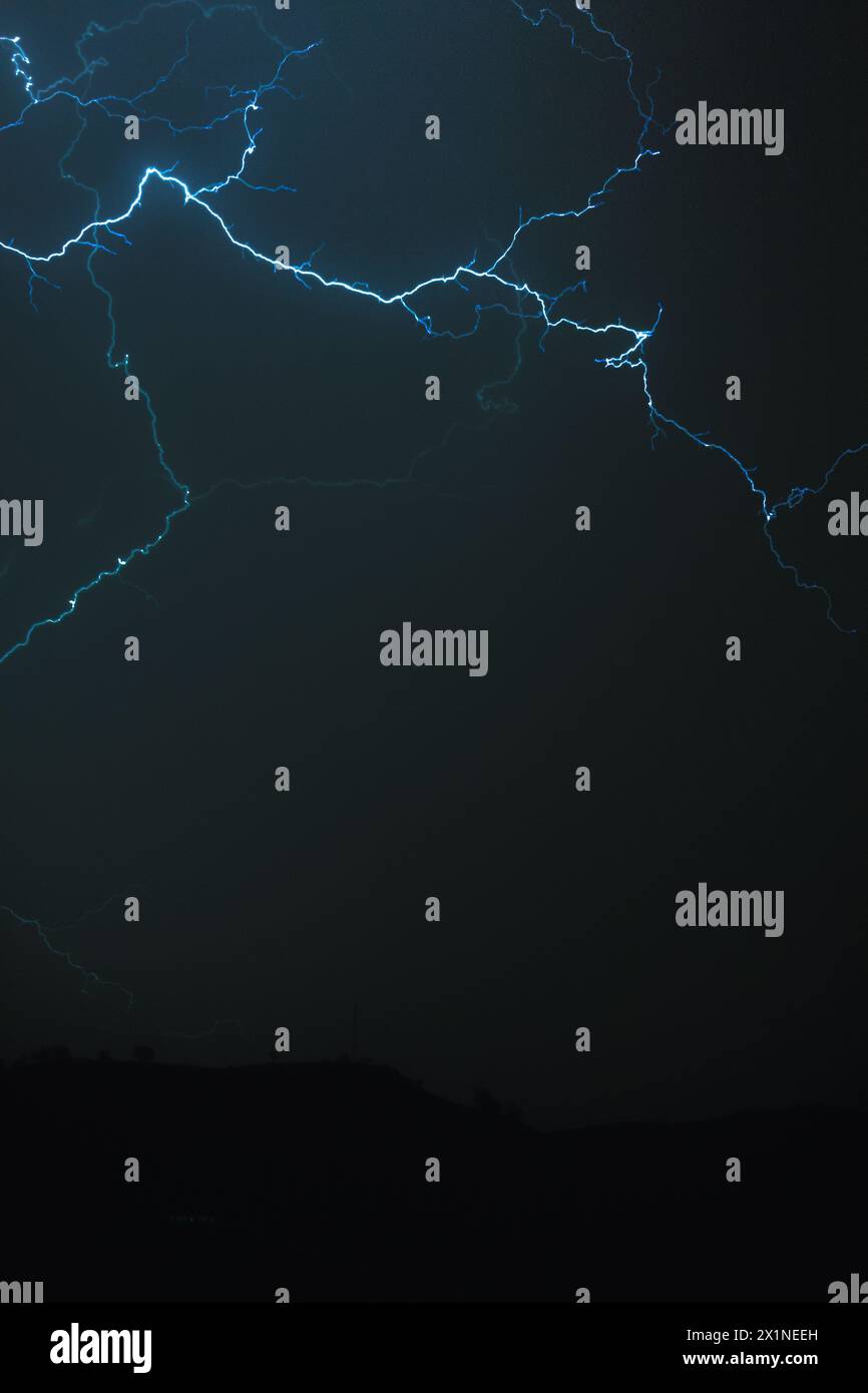 Big blue lightning striking the dark sky. Stock Photo