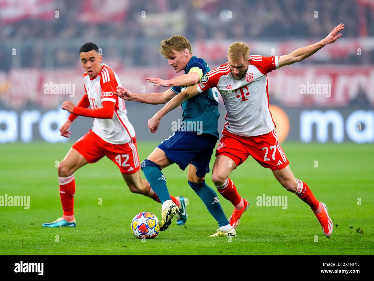 Arsenal's Martin Odegaard (centre) battles for the ball with Bayern Munich's Jamal Musiala and Konrad Laimer during the UEFA Champions League quarter-final, second leg match at the Allianz Arena, Munich. Picture date: Wednesday April 17, 2024. Stock Photo