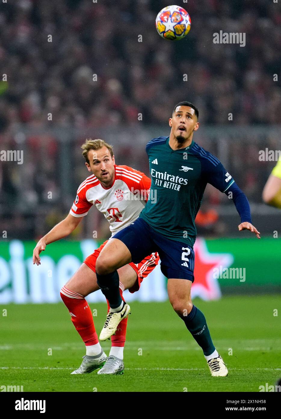 Bayern Munich's Harry Kane (left) and Arsenal's William Saliba battle for the ball during the UEFA Champions League quarter-final, second leg match at the Allianz Arena, Munich. Picture date: Wednesday April 17, 2024. Stock Photo
