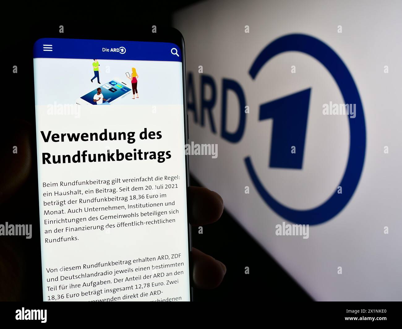 Person holding smartphone with web page of German public-service broadcasting organisation ARD in front of logo. Focus on center of phone display. Stock Photo