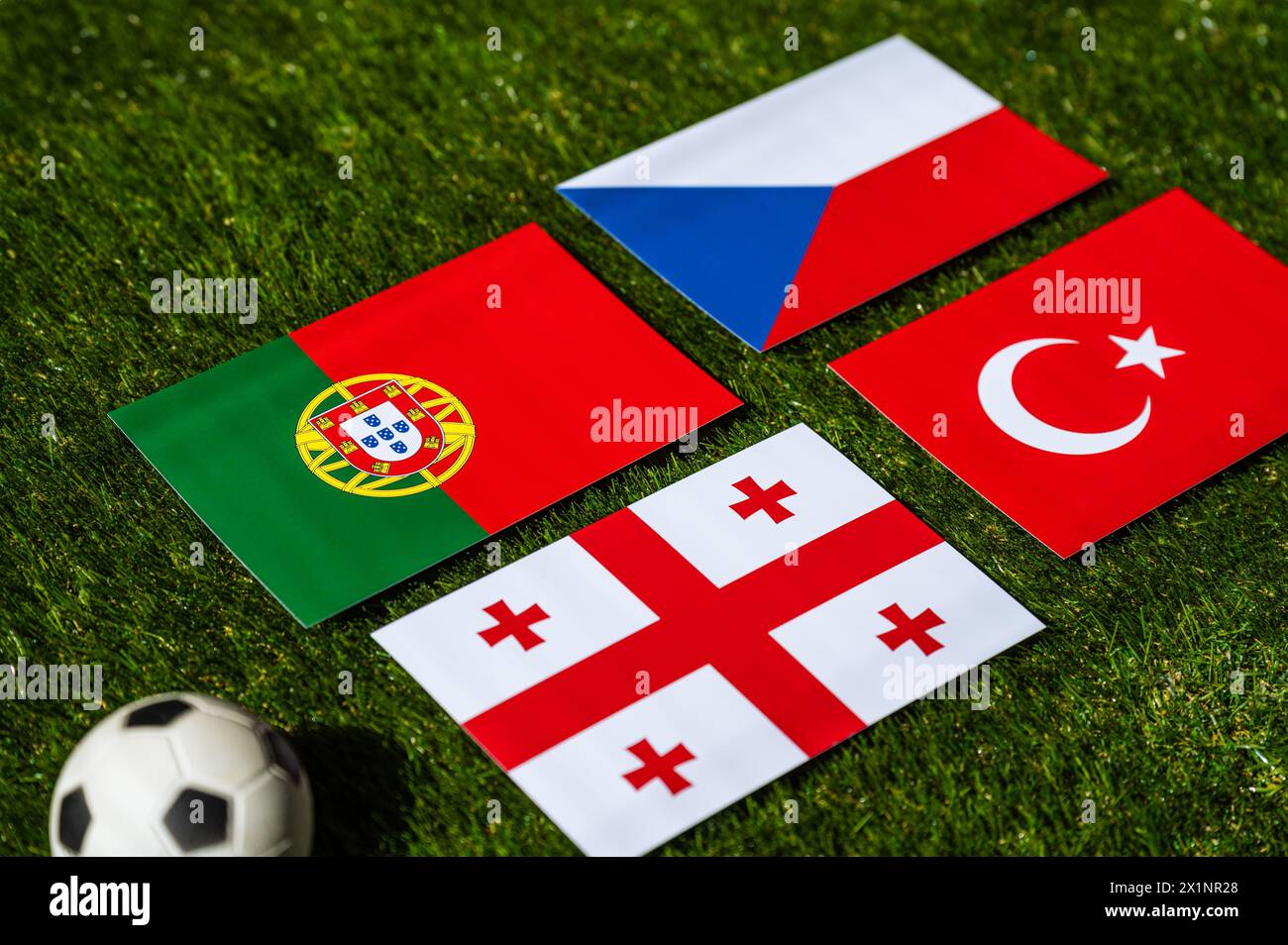 Turkey, Georgia, Portugal, Czech Republic nationals flag and football ball on green grass. Group F at summer tournament 2024 in Germany Stock Photo