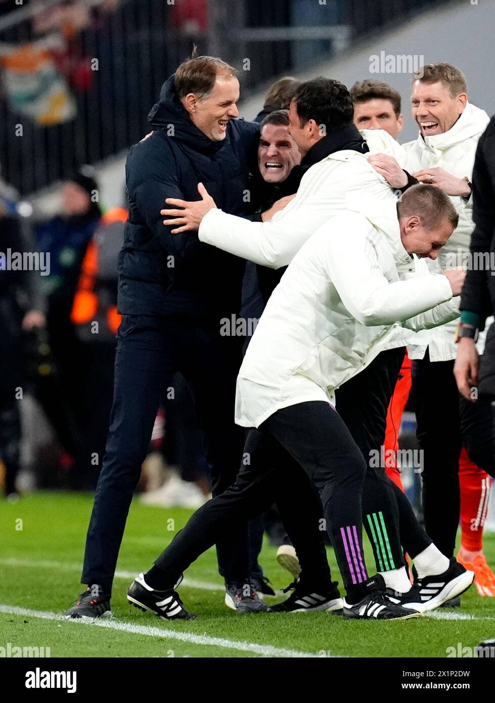 Bayern Munich manager Thomas Tuchel celebrates with assistant coaches Anthony Barry and Zsolt Low at the end of the UEFA Champions League quarter-final, second leg match at the Allianz Arena, Munich. Picture date: Wednesday April 17, 2024. Stock Photo