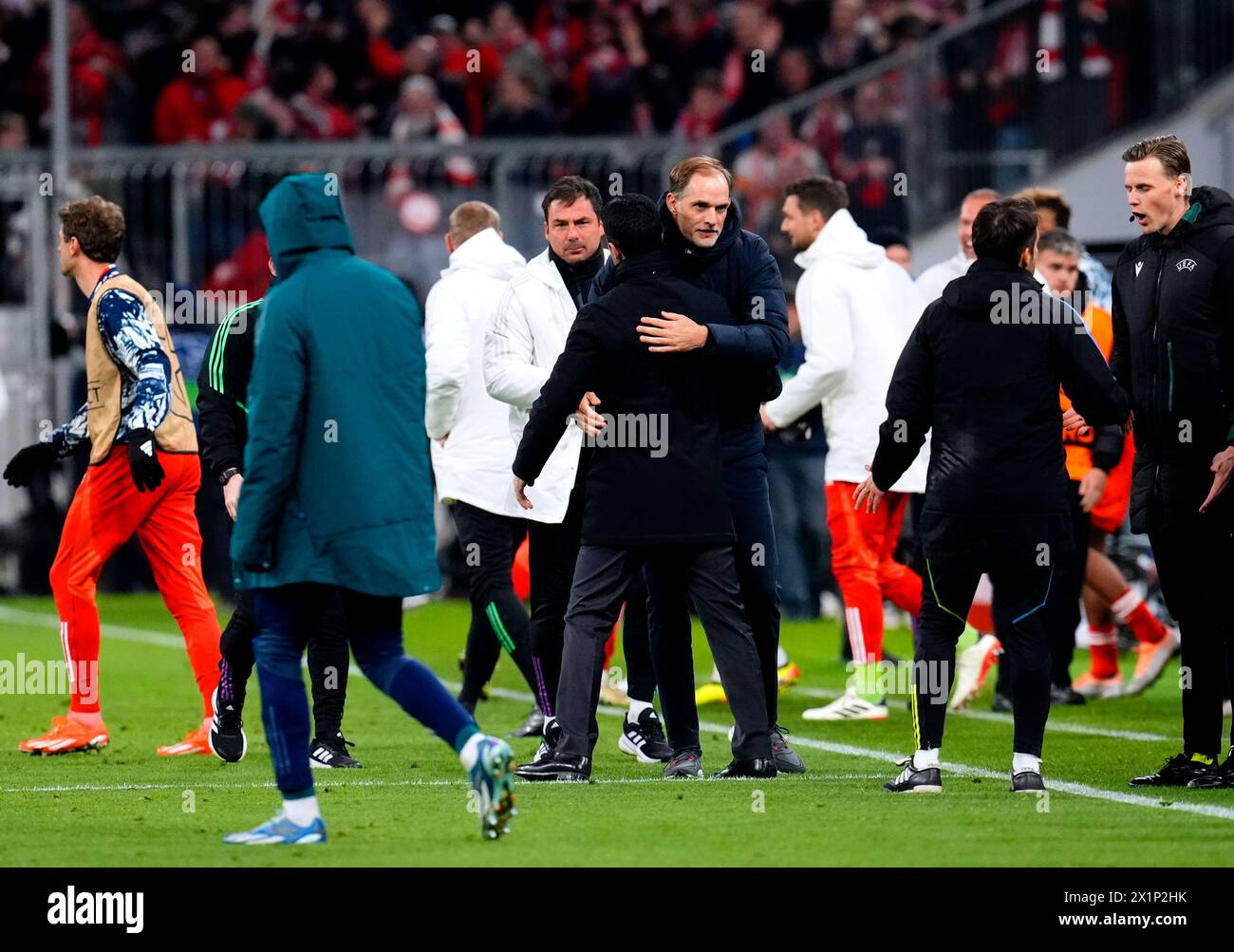 Bayern Munich manager Thomas Tuchel hugs Arsenal manager Mikel Arteta at the end of the UEFA Champions League quarter-final, second leg match at the Allianz Arena, Munich. Picture date: Wednesday April 17, 2024. Stock Photo