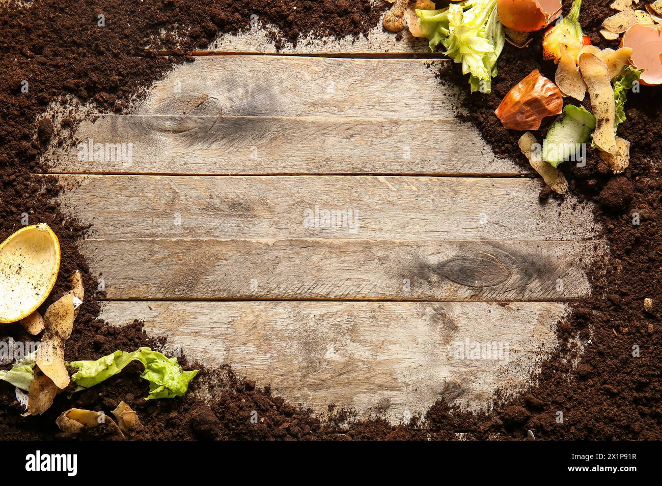 Frame made from organic waste and soil on wooden background. Compost recycling concept Stock Photo