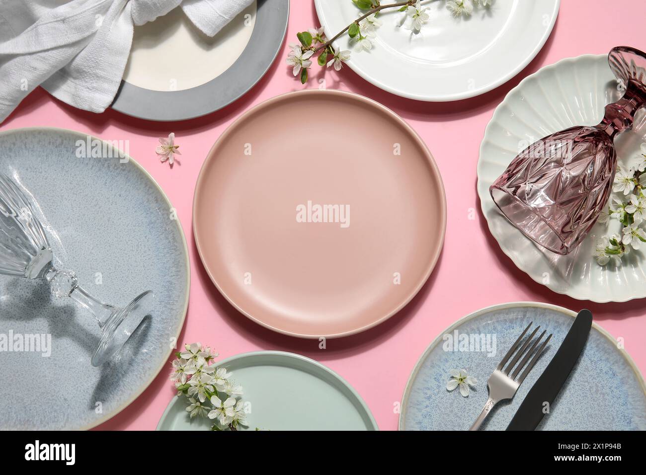Beautiful table setting with blossoming branches on pink background Stock Photo