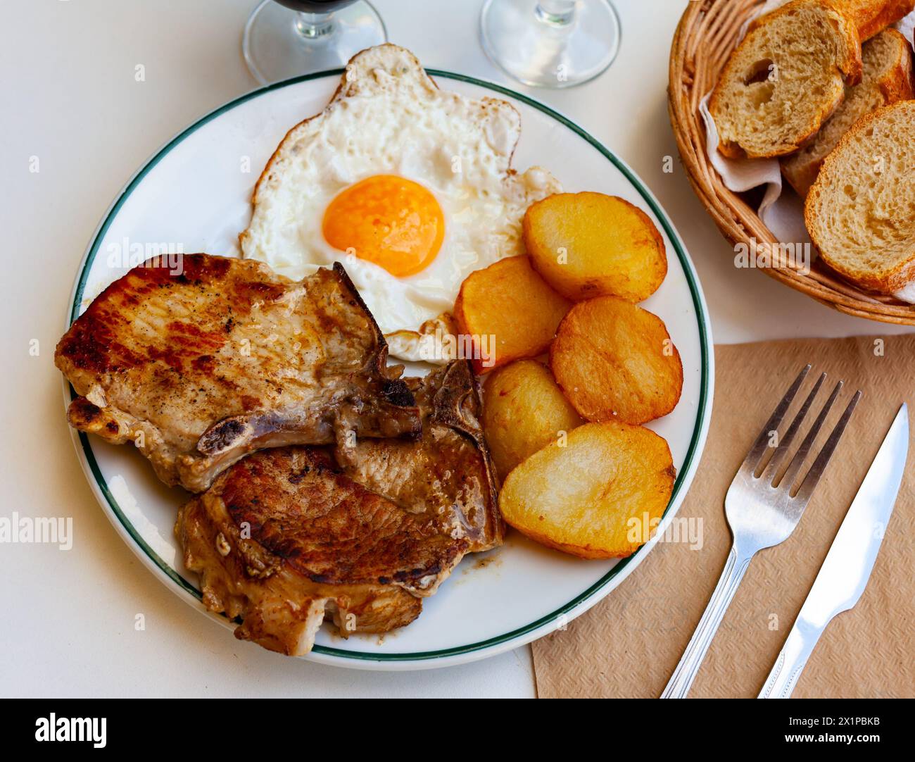 Pork chop with potatoes and scrambled eggs Stock Photo - Alamy