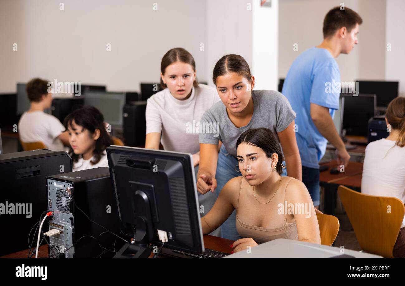 Smart teenagers giving a clue to the focused female co learner while