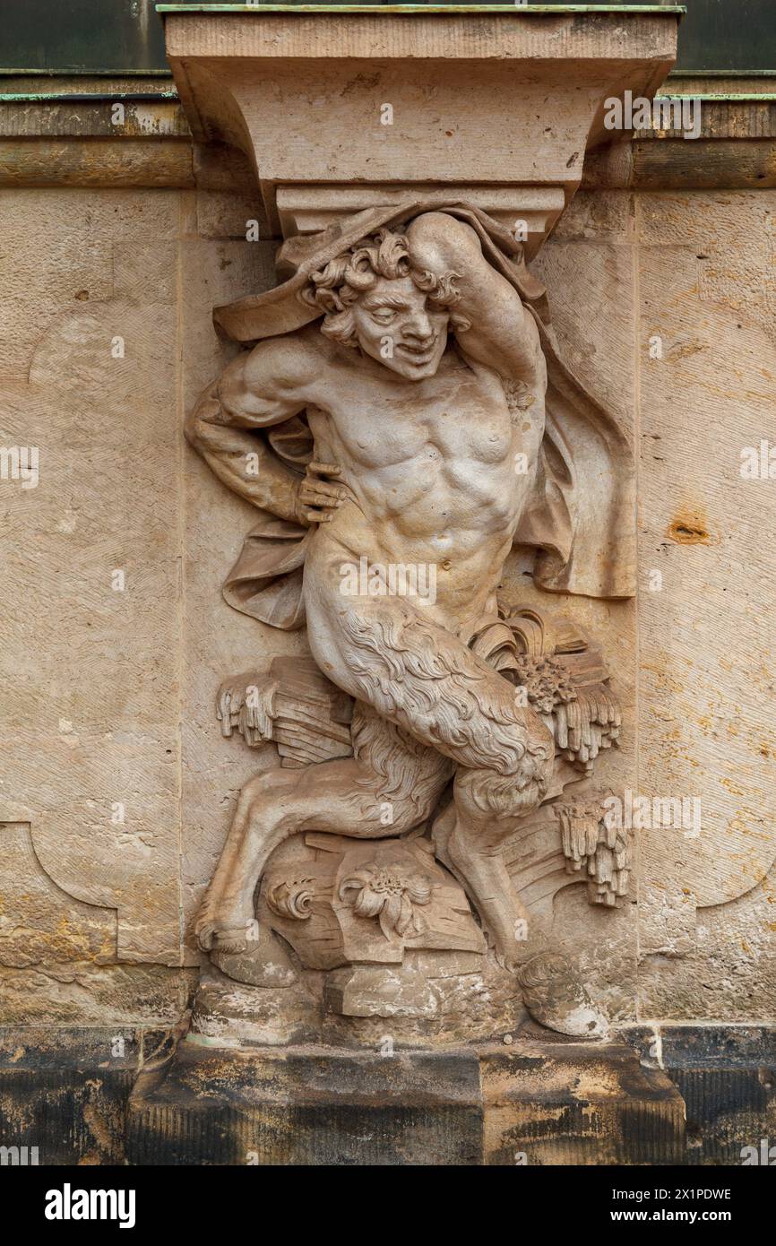 Zwinger palatial complex, statue of a satyr greek mythic creature, half man, half goat on a wall of the palace. Dresden, Germany Stock Photo