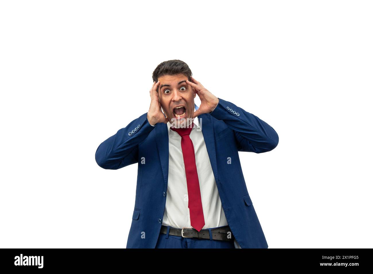 sheer terror on the face of a businessman as he screams with his hands on his head, mouth agape, displaying a look of horror and panic. With an expres Stock Photo