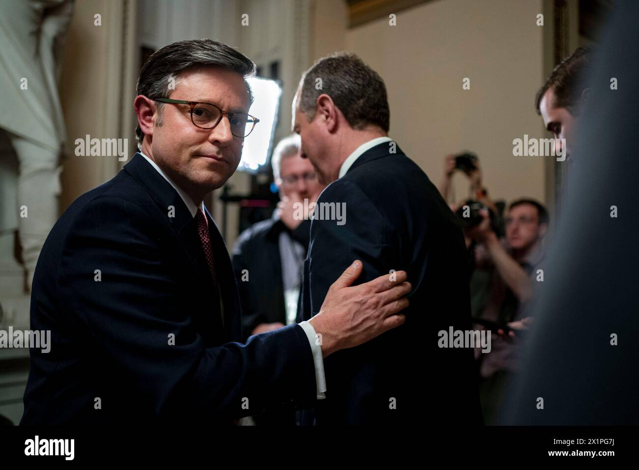 Speaker of the House Mike Johnson, R-LA, pats the arm of Rep. Adam Schiff, D-NY, after speaking with Jake Tapper on CNN outside the House Chambers after the Senate concluded impeachment proceedings against Secretary of Homeland Security Alejandro Mayorkas at the U.S. Capitol in Washington, DC on Wednesday, April 17, 2024. The Senate, which voted along party lines, dismissed the two charges accusing Mayorkas of failing to enforce immigration laws and breaching the public trust as unconstitutional because they did not meet the bar of a high crime or misdemeanor. Photo by Bonnie Cash/UPI. Stock Photo