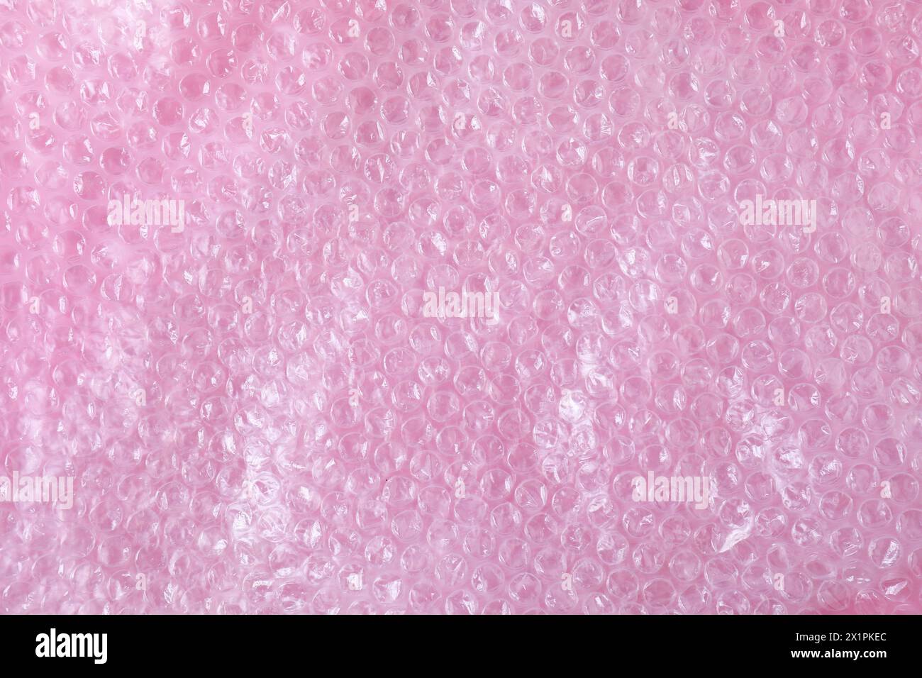 Transparent bubble wrap on pink background, top view Stock Photo