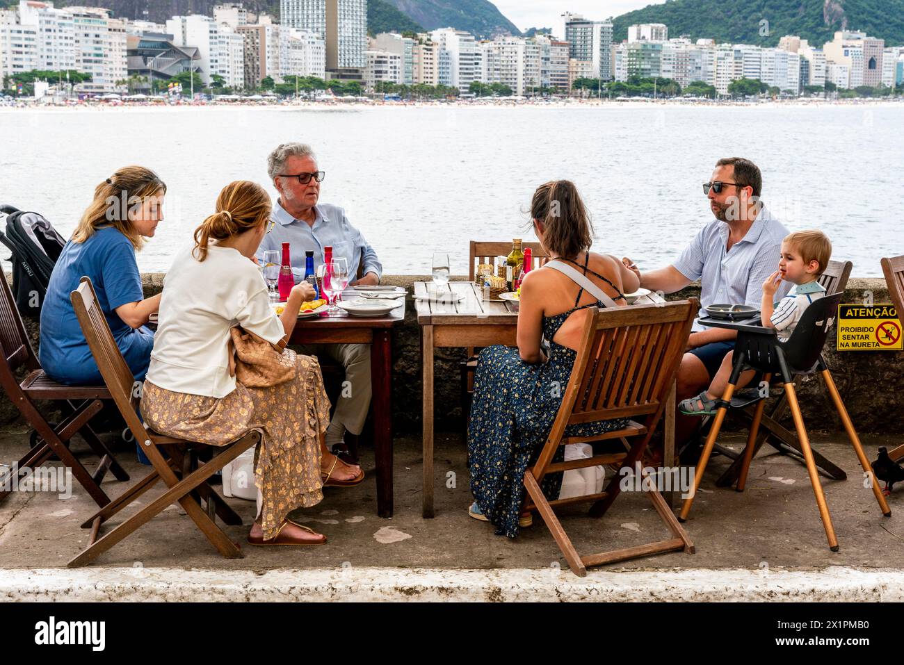 Affluent Brasilian People Enjoy Lunch At The Copacabana Fort With Views of Copacabana Beach, Rio de Janeiro, Brasil. Stock Photo