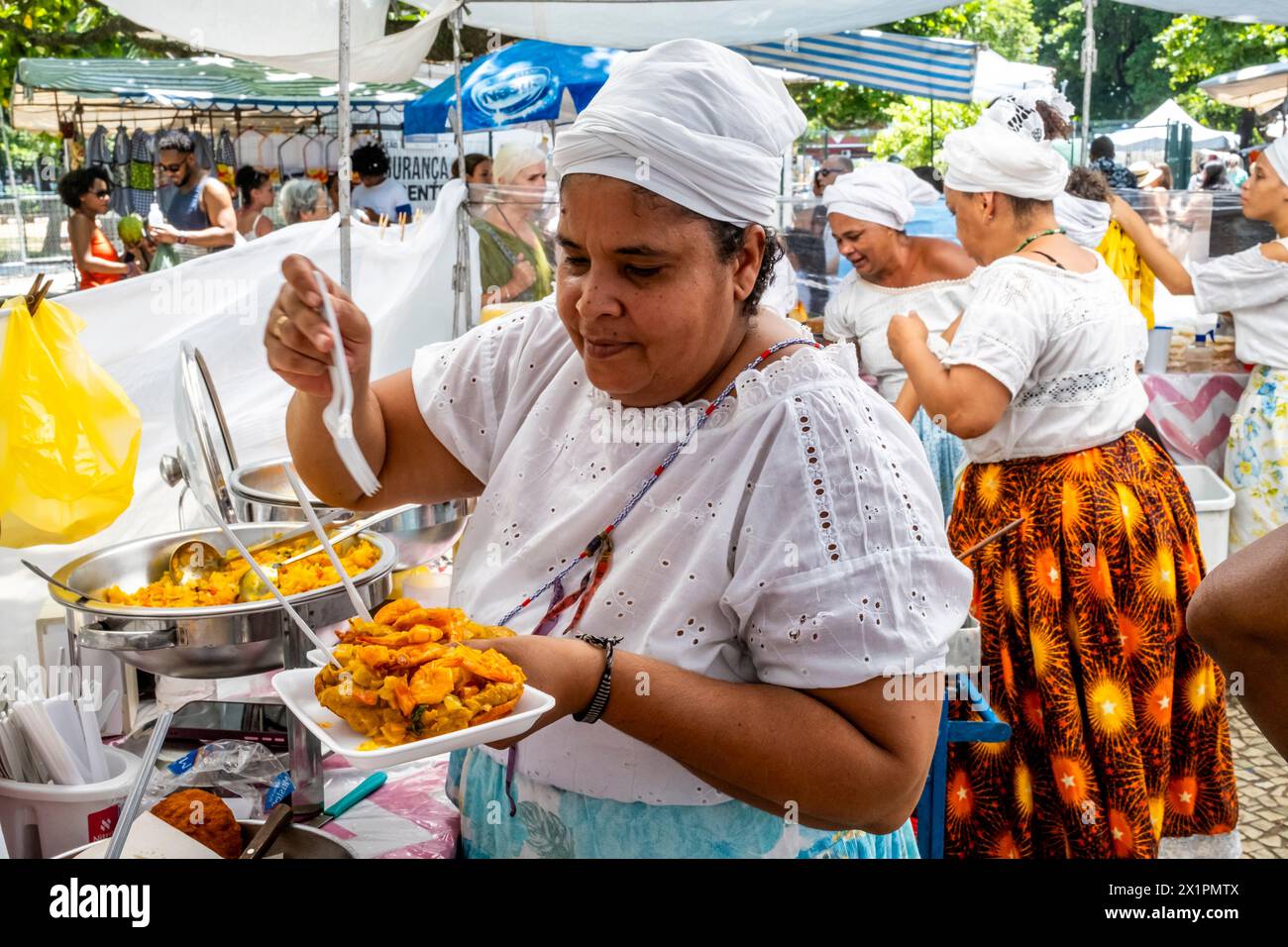 Brasilian Women In Traditional Costume Serve Food At A Cafe At The Ipanema Sunday Market (Hippie Fair), Rio de Janeiro, Rio de Janeiro State, Brasil. Stock Photo