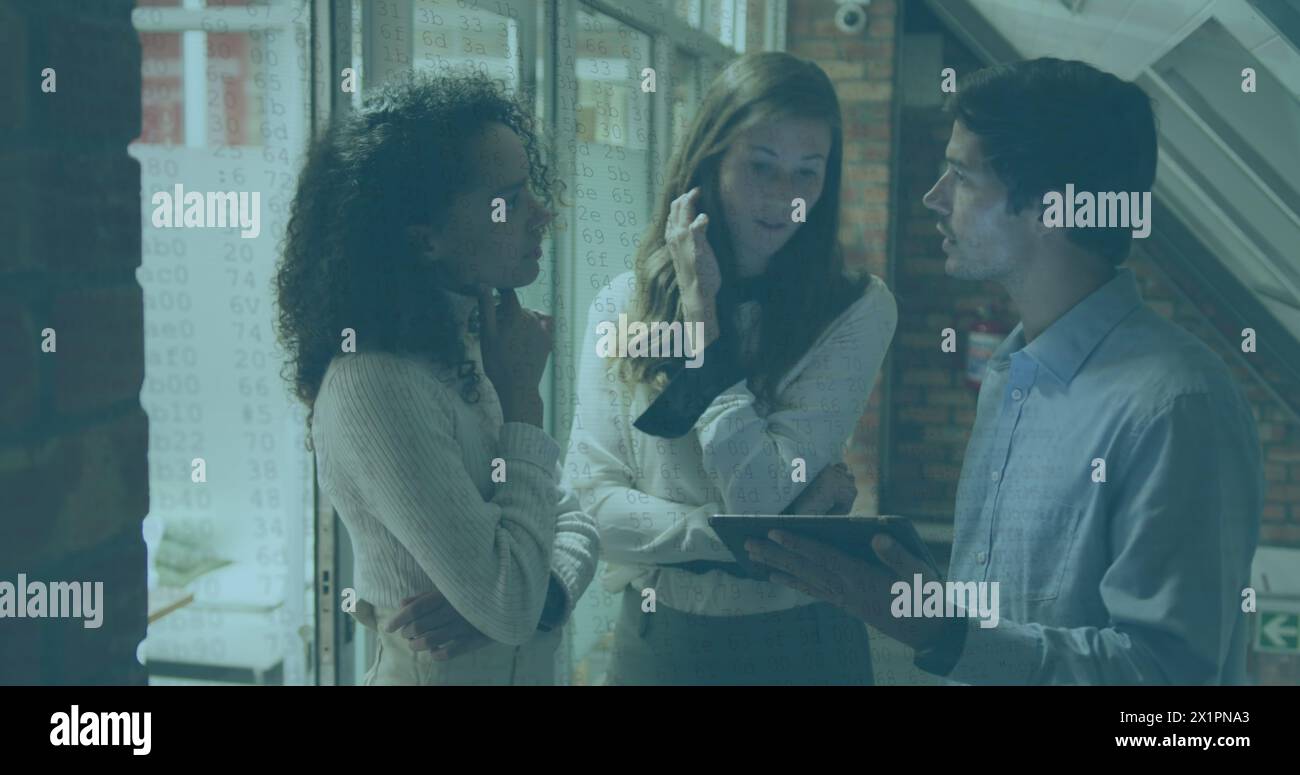 Diverse group of young adults discussing over tablet Stock Photo