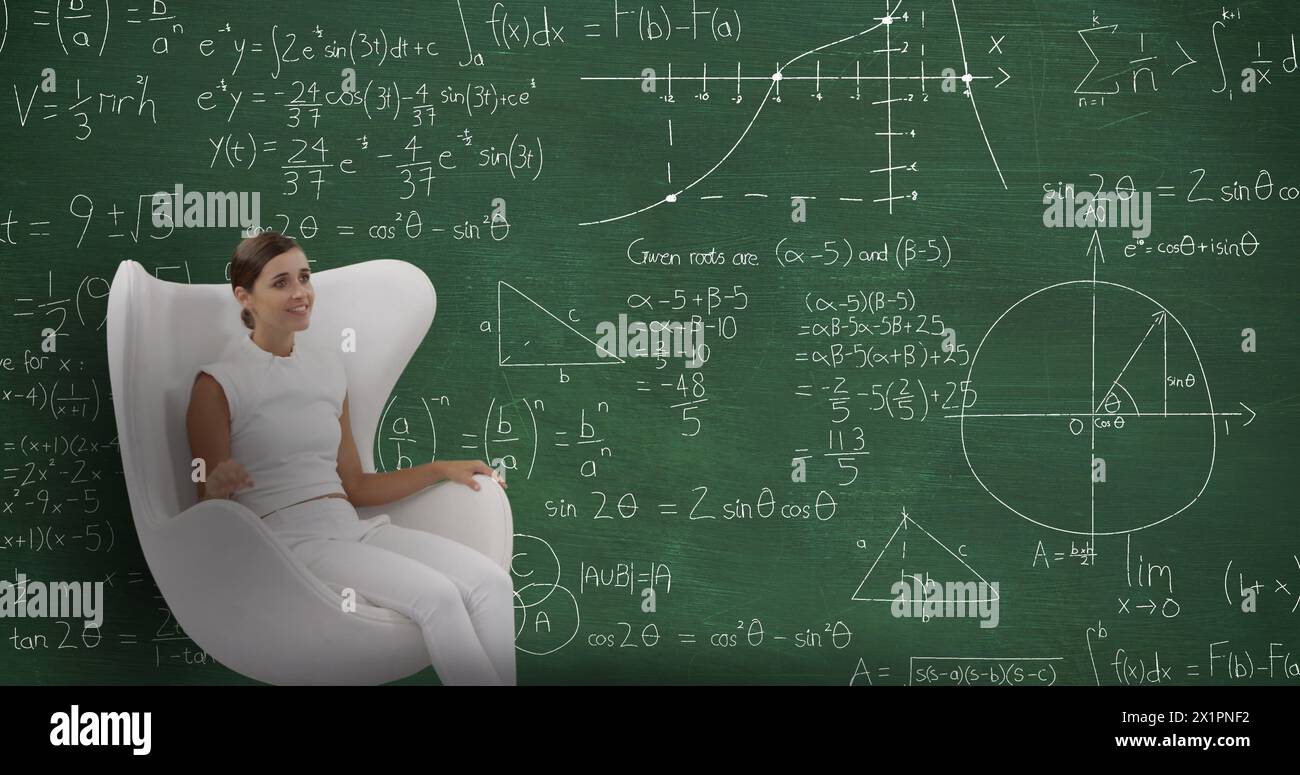 Caucasian female sitting in front of blackboard filled with math equations Stock Photo