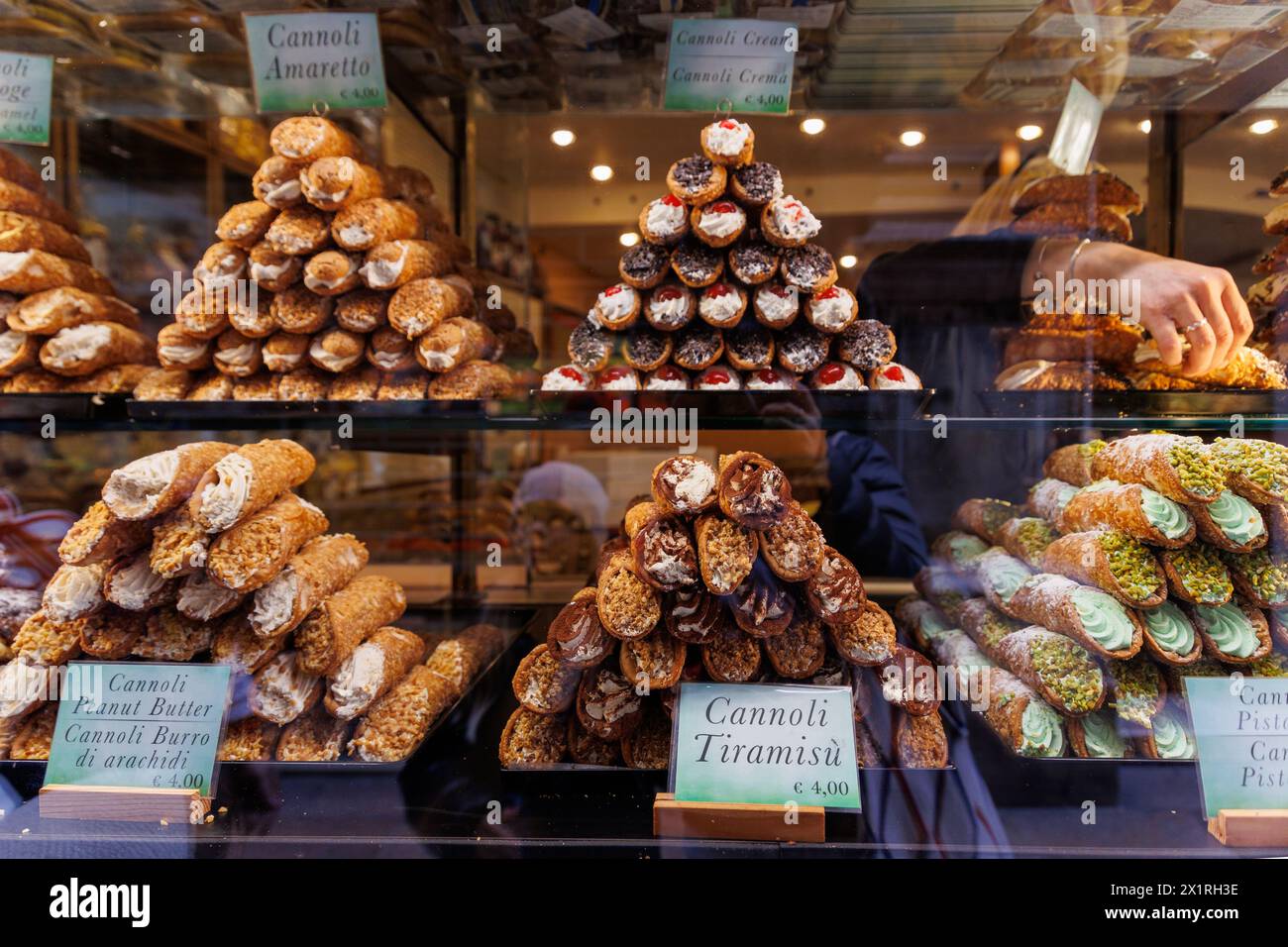 Venice, Italy, 2024.03.29: Delicious Cannoli Pastries with different toppings for Sale In a Cafe, Deli Or Bakery Stock Photo