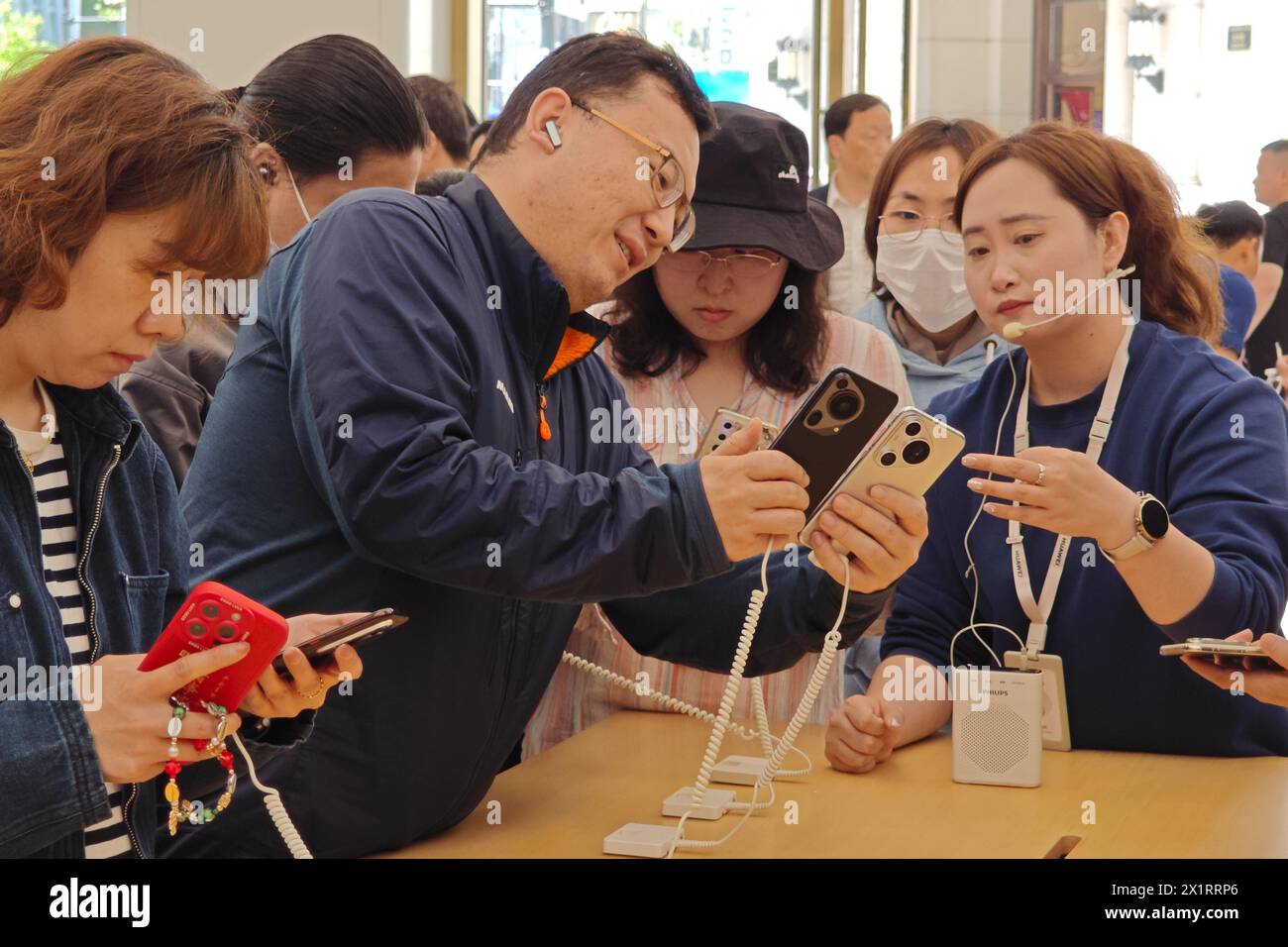 SHANGHAI, CHIAN - APRIL 18, 2024 - Customers experience various functions and features of Huawei's newly released Pura70 mobile phone at the Huawei fl Stock Photo