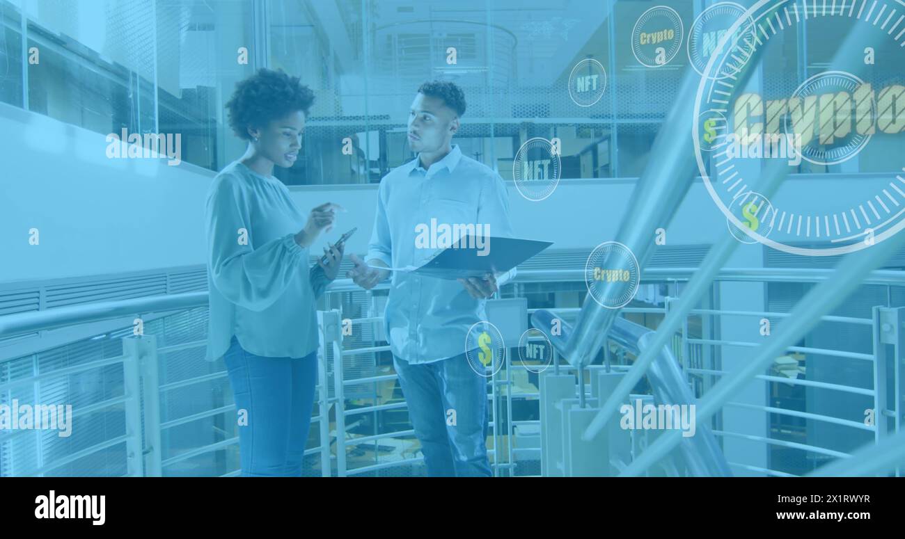 African American junior team member and biracial co-worker discussing Stock Photo