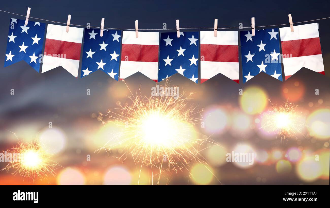 Closeup view of the American flag hanging on the rope with fireworks ...