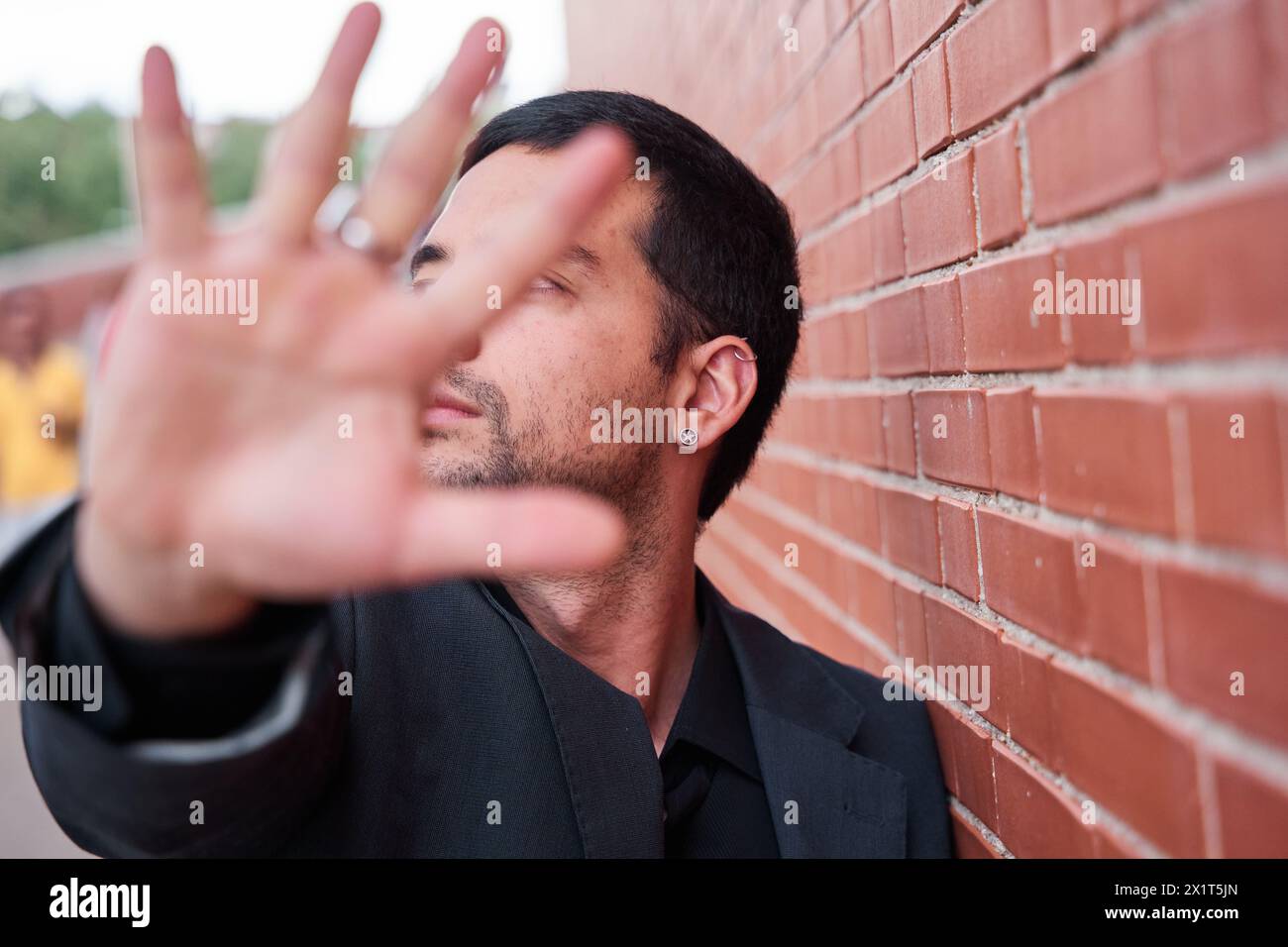 Silence in defiance A man covers his face with his hand in protest