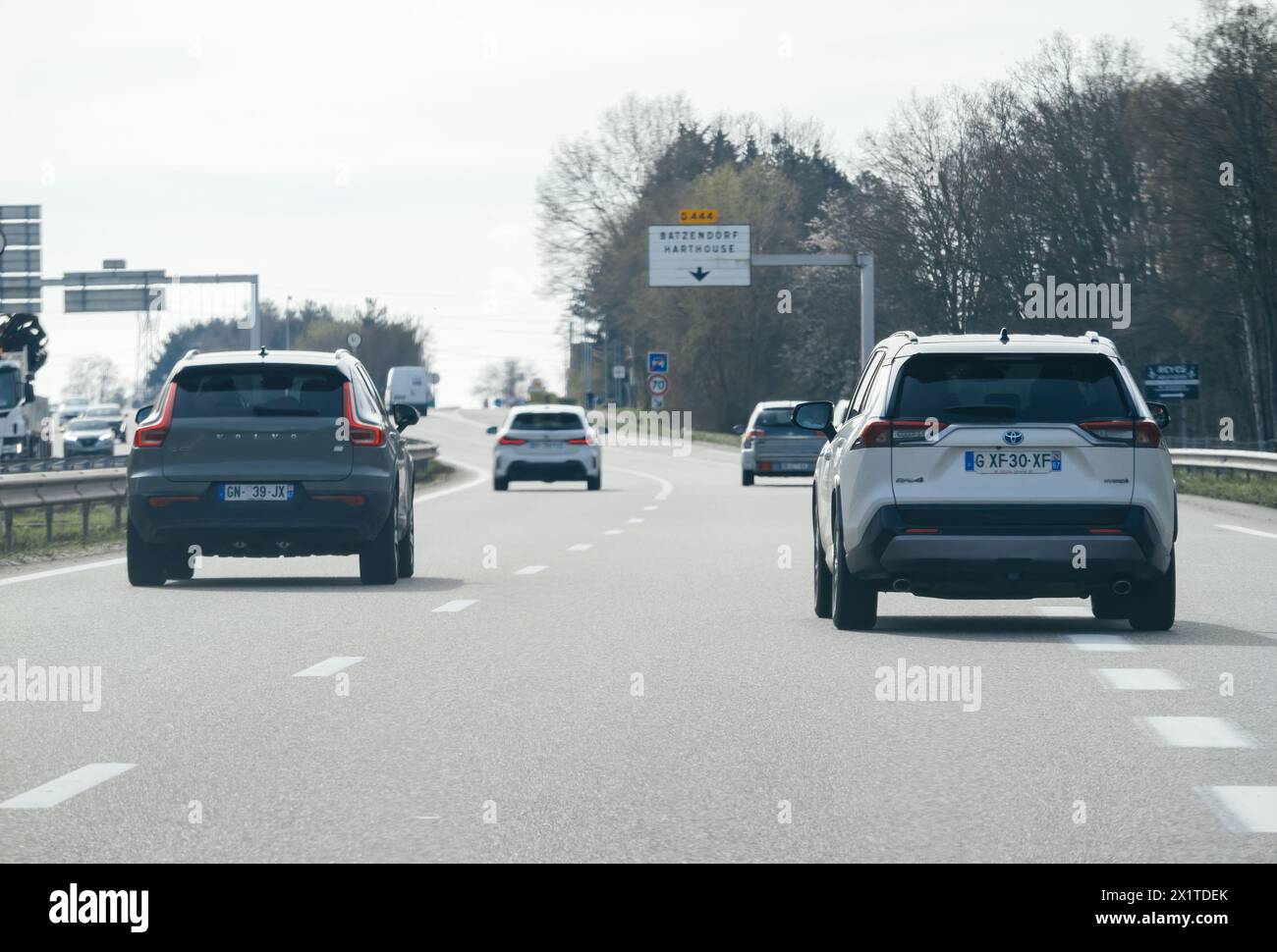 Paris, France - Mar 20, 2024: Toyota, Volvo, and BMW cars drive fast on ...