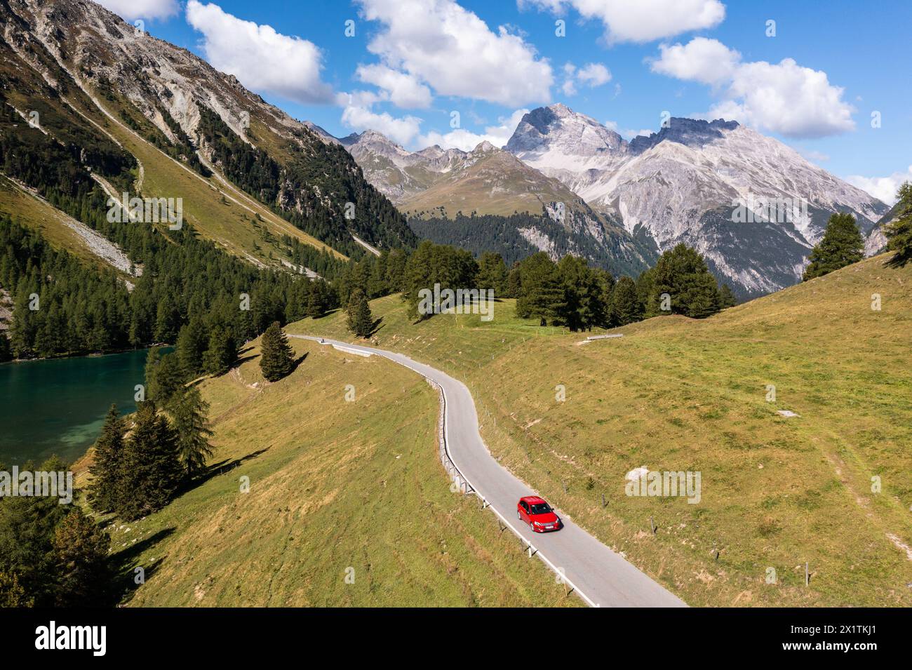 Car driving on the Albula mountain pass road in the alps in Canton Graubunden in Switzerland on a sunny summer day Stock Photo