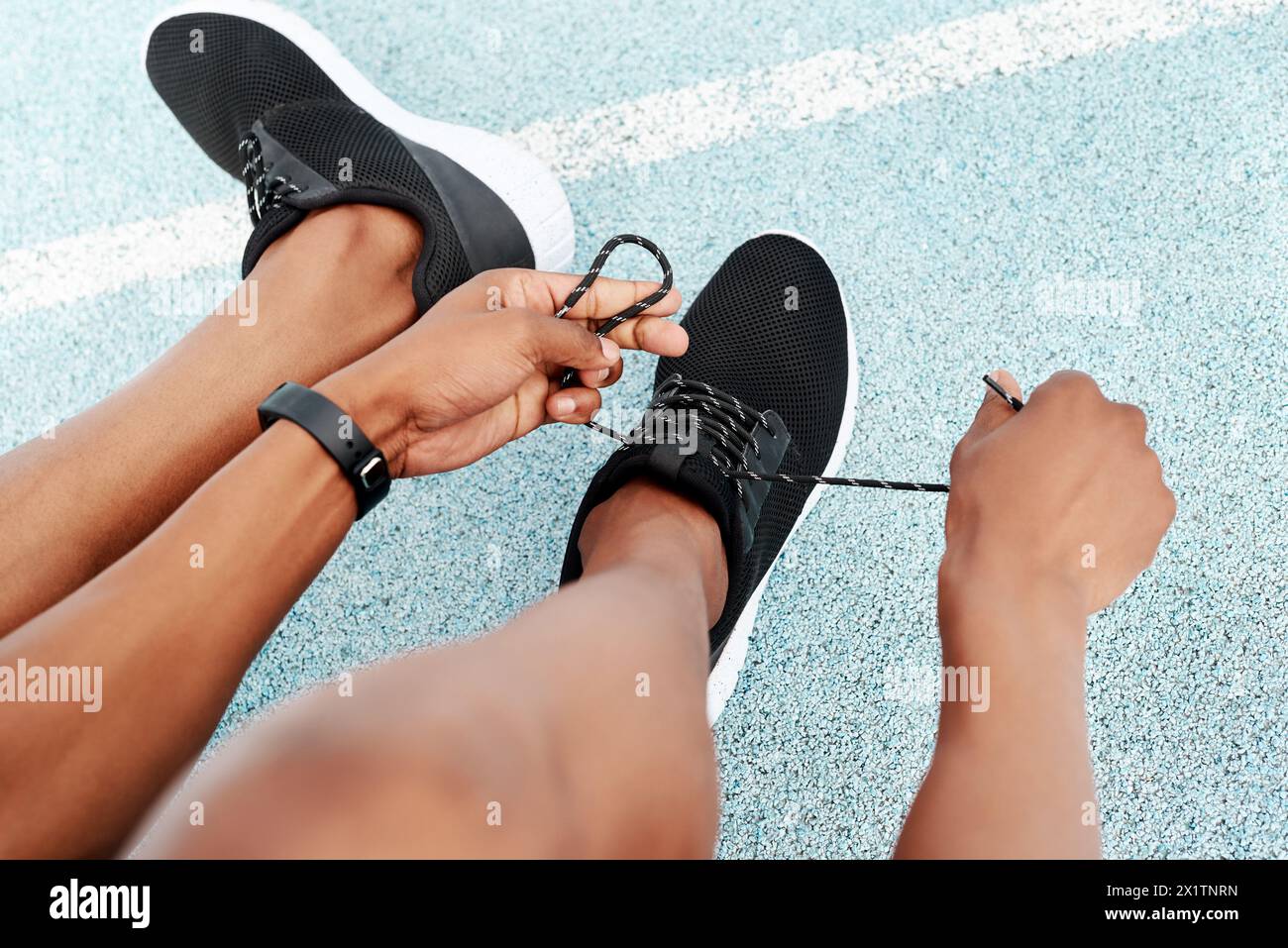 Fitness, shoes and hands of runner person at stadium for training, workout or morning cardio. Shoelace, pov or athlete at arena for race track Stock Photo