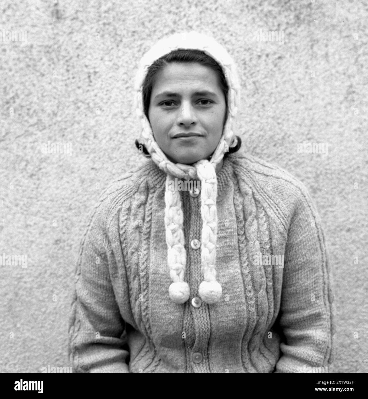 Socialist Republic of Romania in the 1970s. Portrait of a young woman wearing handmade knitted hat and sweater. Stock Photo