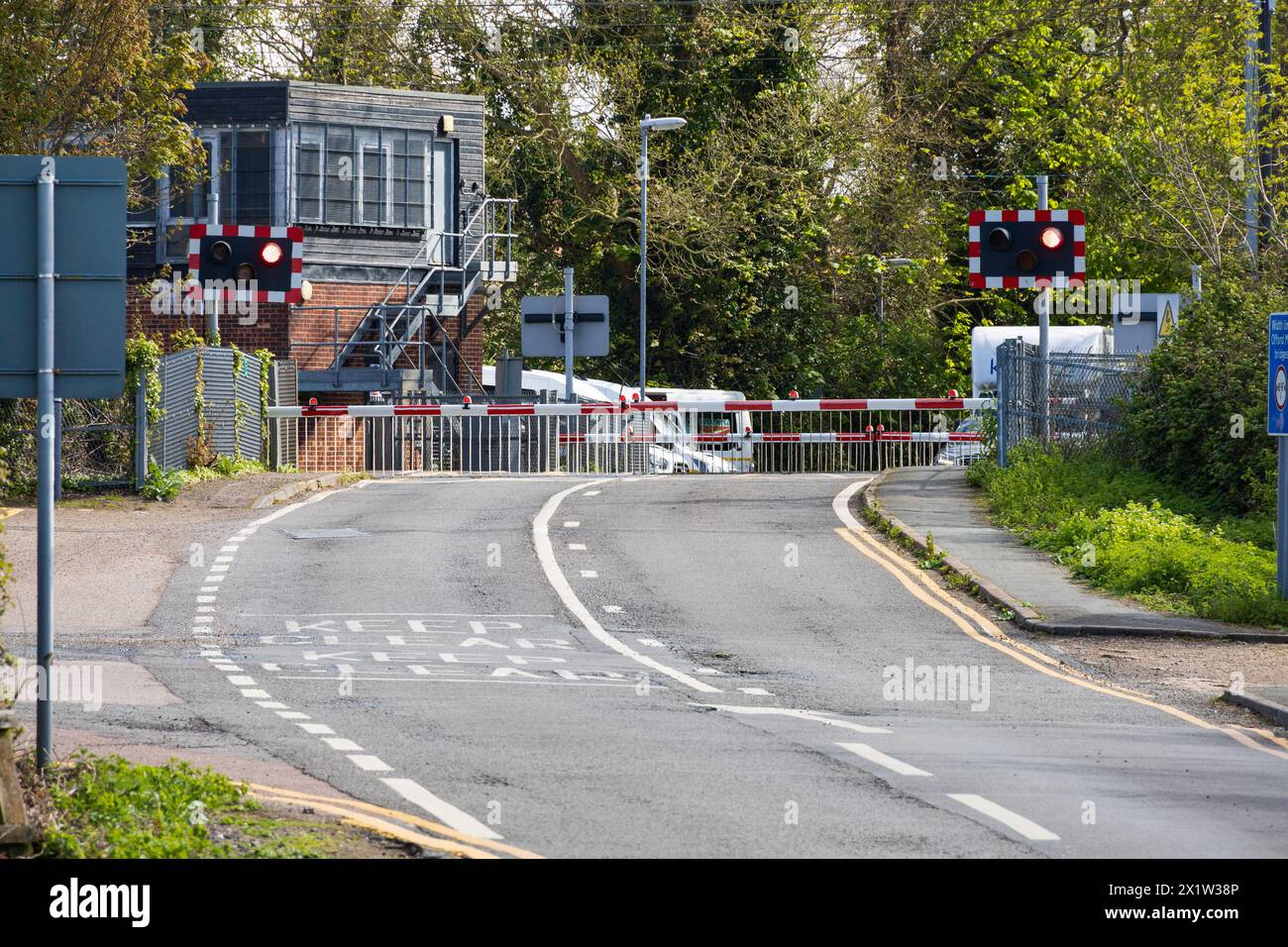 Signal Box and level crossing with gates down at Offord Cluny, Cambridgeshire, England Stock Photo
