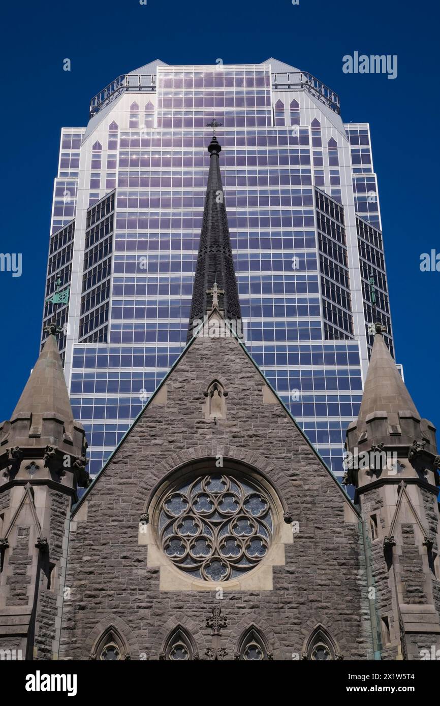 Old Christ Church Cathedral facade with rose window and modern architectural steel and blue tinted glass windows KPMG office tower in summer, Montreal Stock Photo