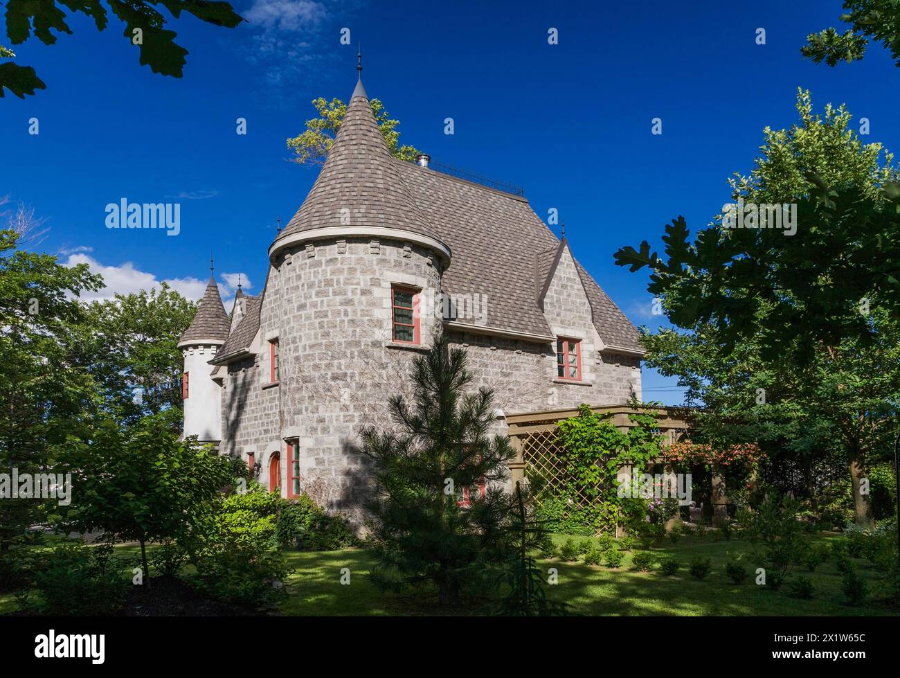 2006 reproduction of a 16th century grey stone and mortar Renaissance castle style residential home facade in summer, Quebec, Canada Stock Photo