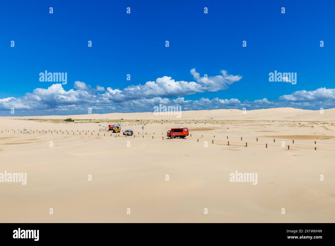 Tourist Trucks driving on Sand Dunes at Stockton Beach, New South Wales, Australia. Stock Photo