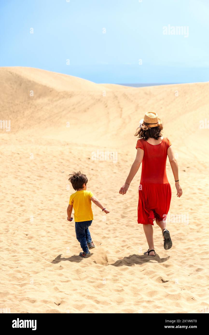 Mother and son tourists on vacation in the dunes of Maspalomas, Gran Canaria, Canary Islands Stock Photo