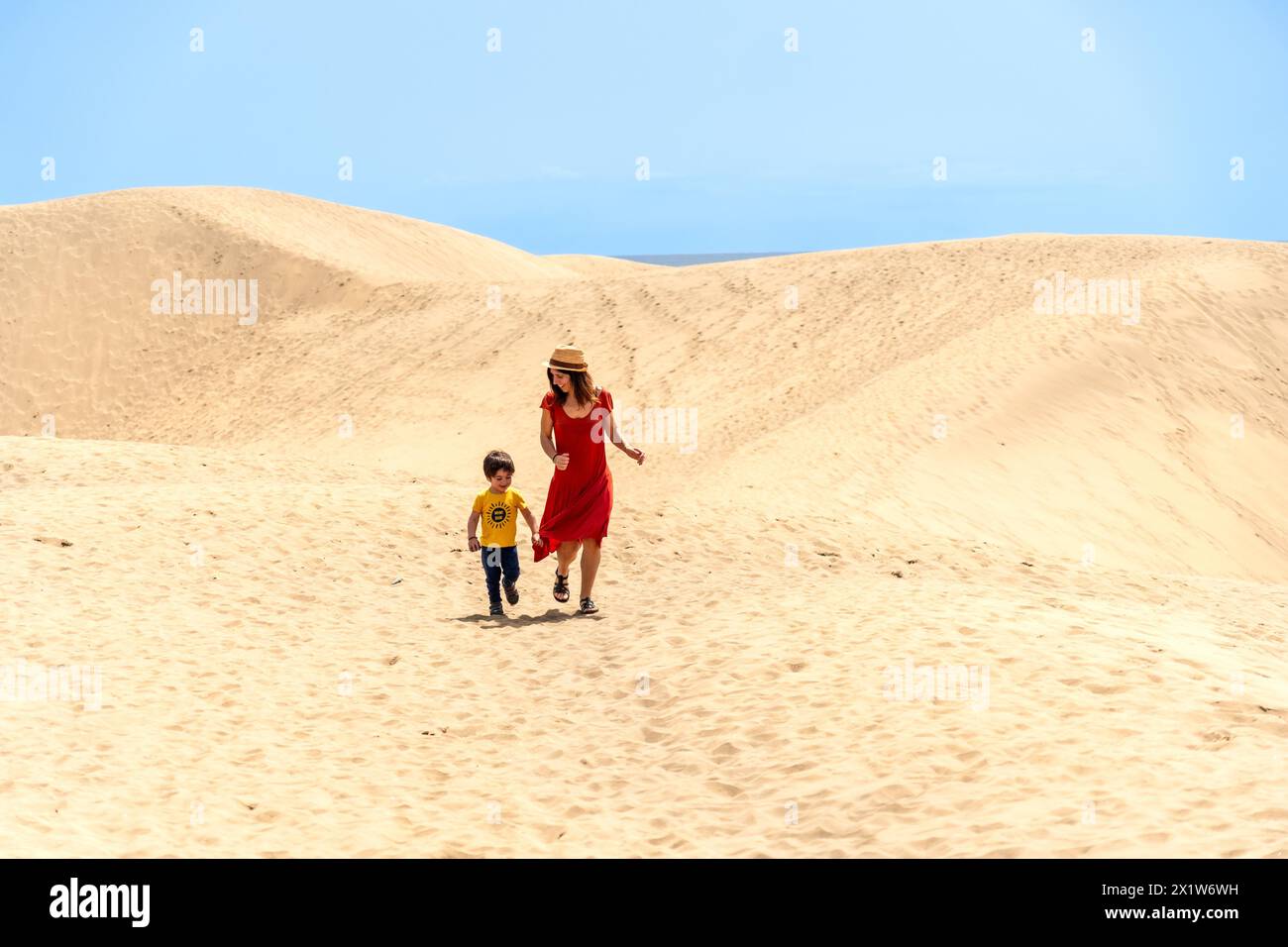 Mother and son tourists on vacation in the dunes of Maspalomas, Gran Canaria, Canary Islands Stock Photo