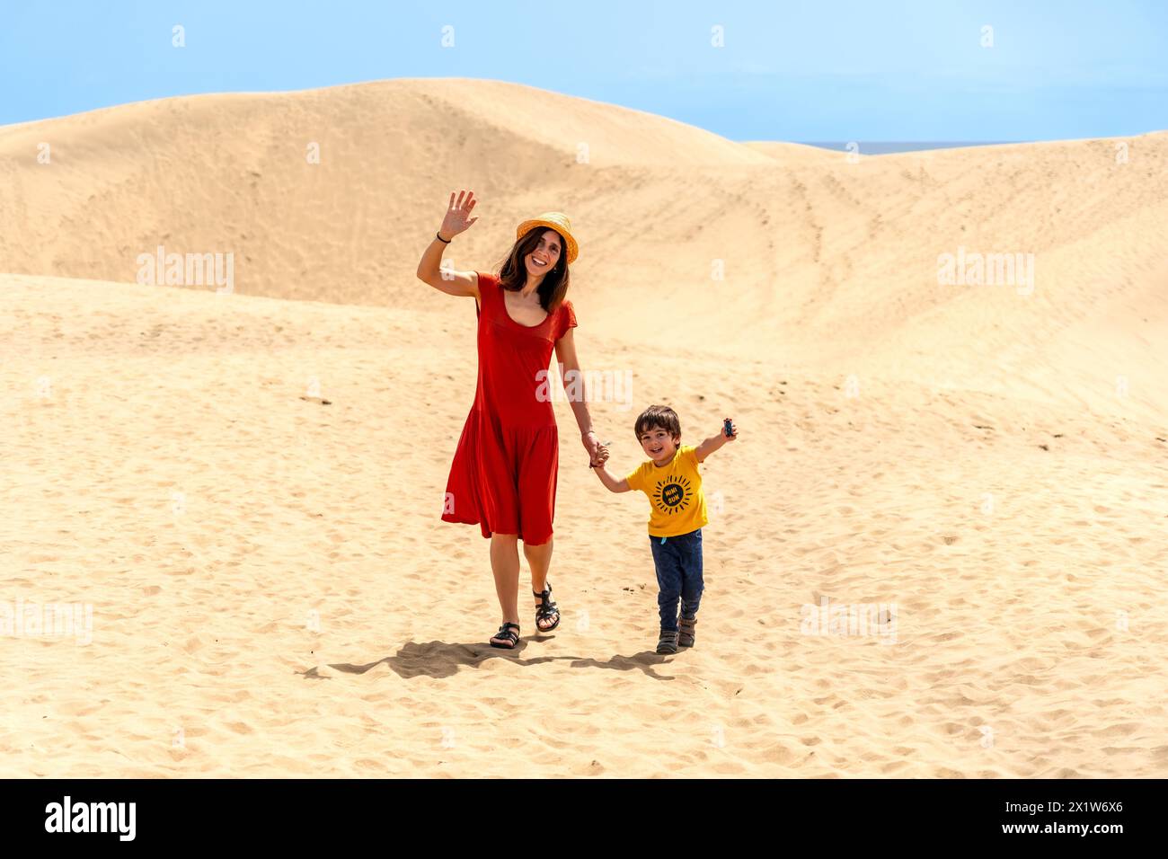 Mother and son tourists enjoying in the dunes of Maspalomas, Gran Canaria, Canary Islands Stock Photo