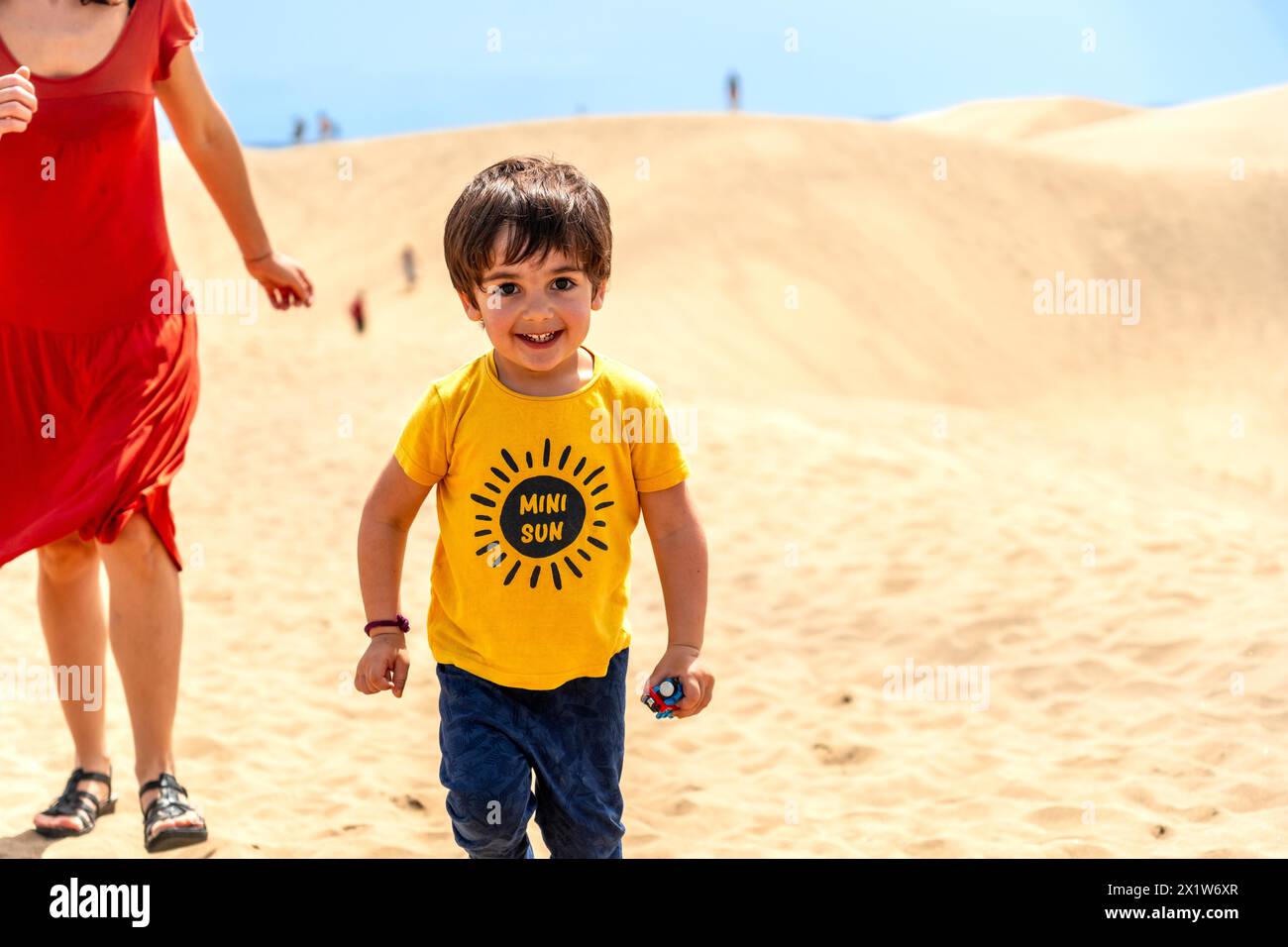 Mother and son on vacation smiling in the dunes of Maspalomas, Gran Canaria, Canary Islands Stock Photo