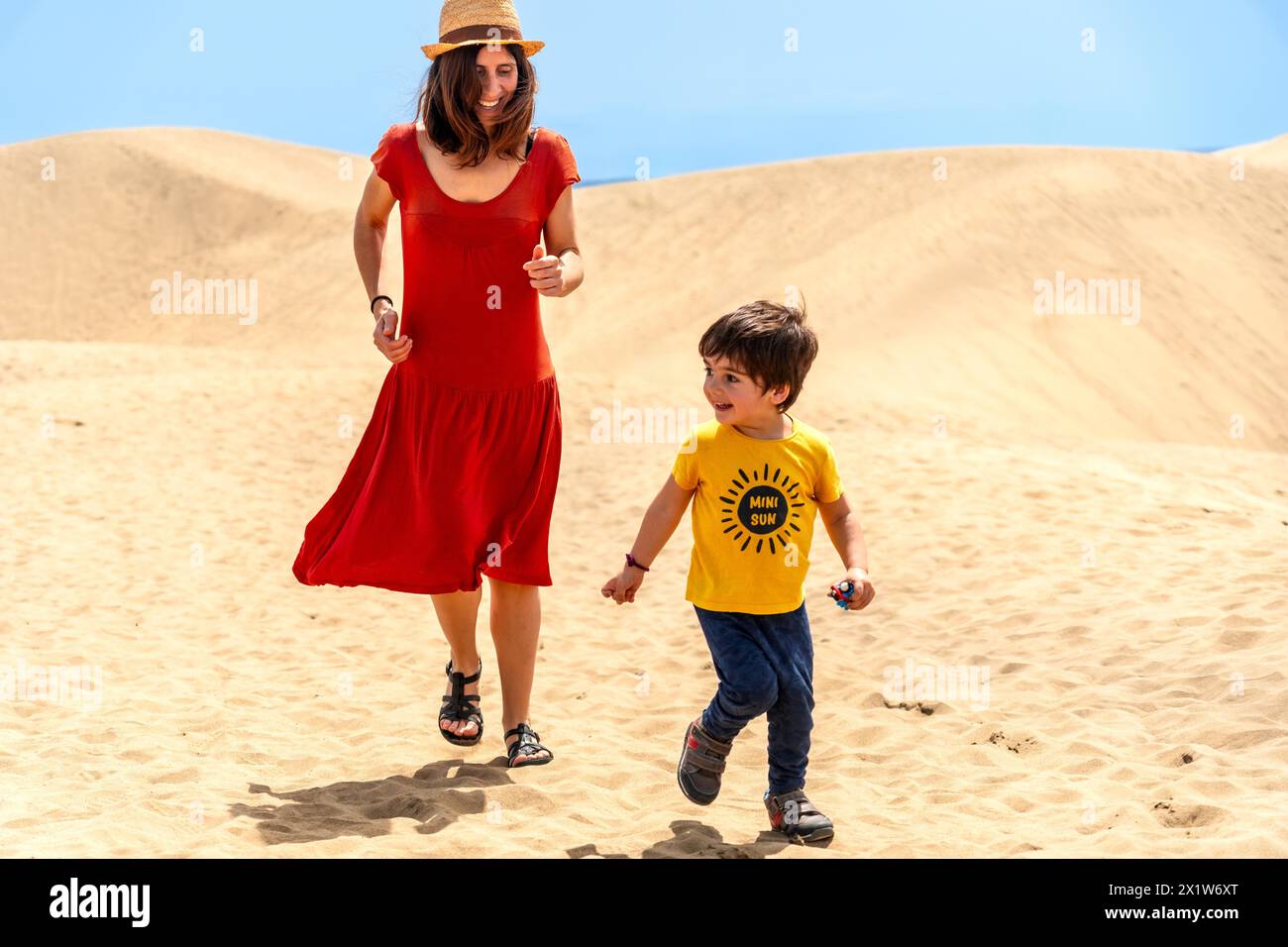 Mother and son on vacation smiling in the dunes of Maspalomas, Gran Canaria, Canary Islands Stock Photo