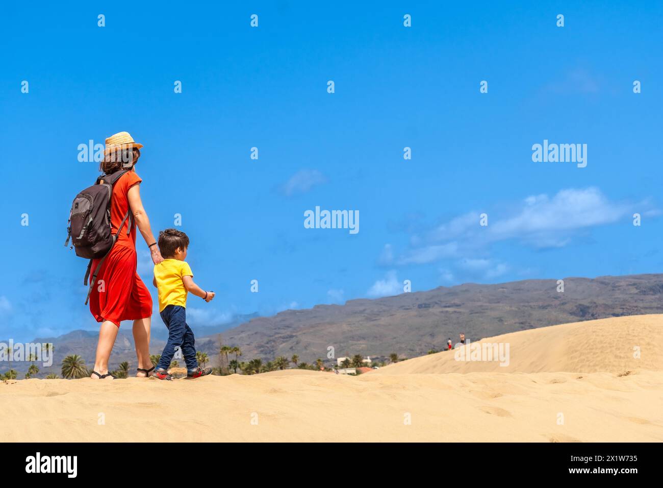 Mother and son enjoying in the dunes of Maspalomas on vacation, Gran Canaria, Canary Islands Stock Photo