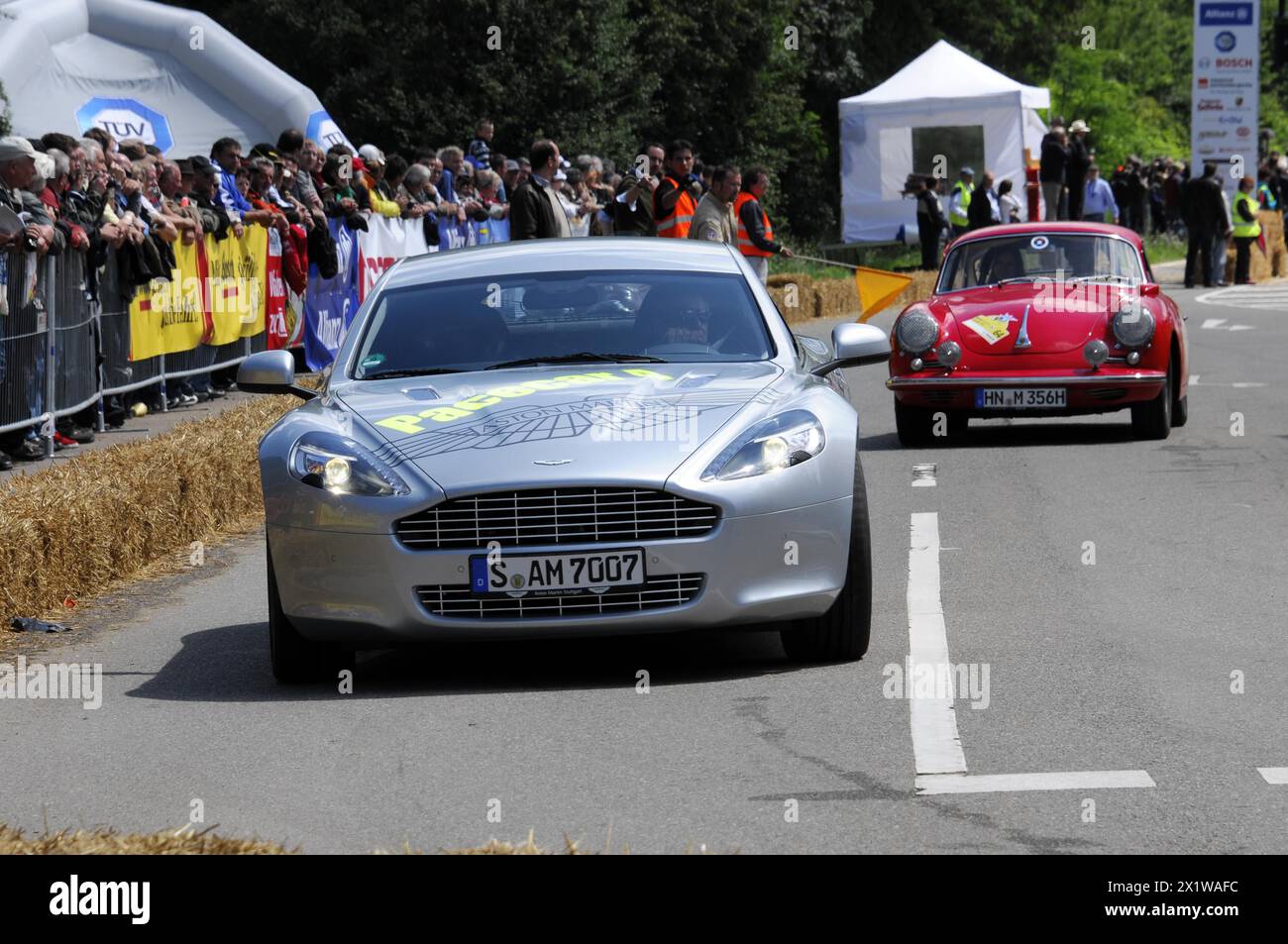 Silver Aston Martin leads a red Alfa Romeo in a classic car race, SOLITUDE REVIVAL 2011, Stuttgart, Baden-Wuerttemberg, Germany Stock Photo