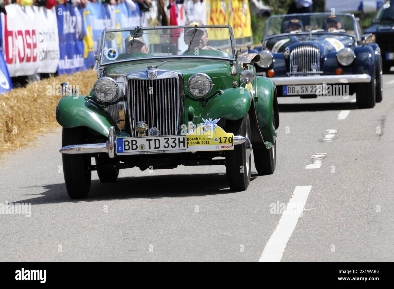A green MG vintage car at a road race, surrounded by spectators, SOLITUDE REVIVAL 2011, Stuttgart, Baden-Wuerttemberg, Germany Stock Photo
