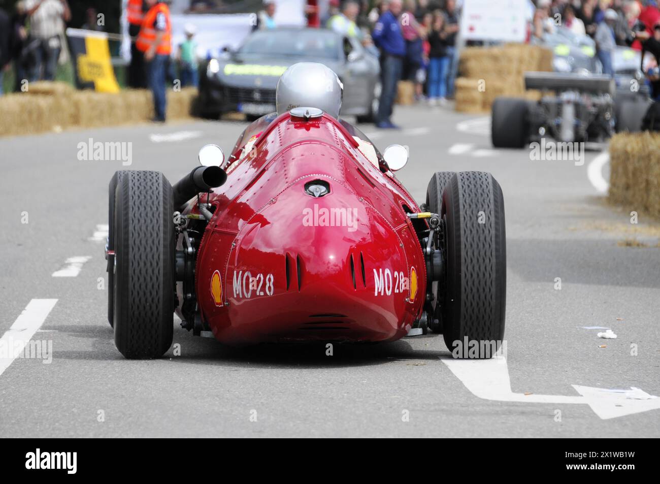 Rear view of a red historic racing car on the road with driver in helmet, SOLITUDE REVIVAL 2011, Stuttgart, Baden-Wuerttemberg, Germany Stock Photo