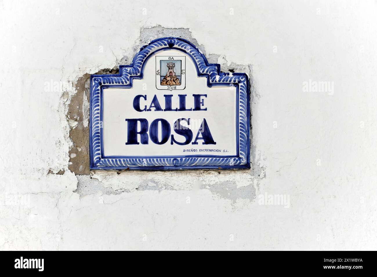 Solabrena, A white and blue ceramic sign on a wall shows 'Calle Rosa ...