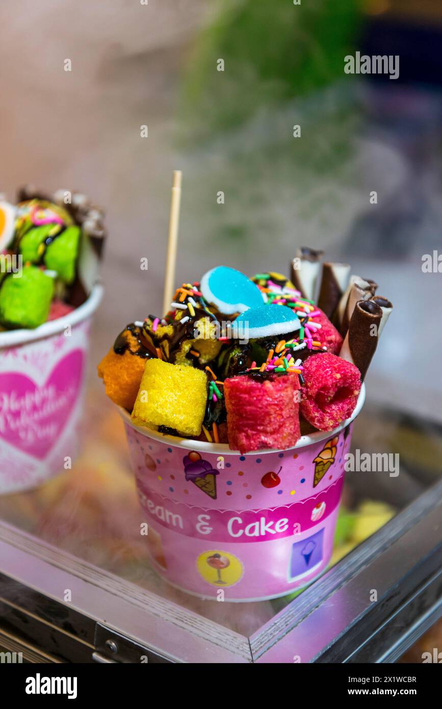 Ice cream sundae with cake on a market stall, sweets, sugar, unhealthy, colourful, gaudy, colourful, decorated, decoration, enough, sweet, colourful Stock Photo