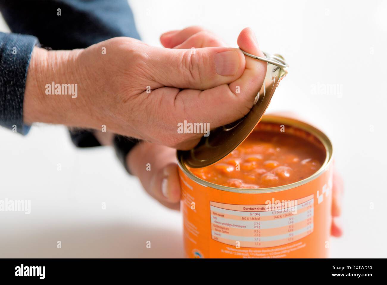 Opening a tin can Stock Photo
