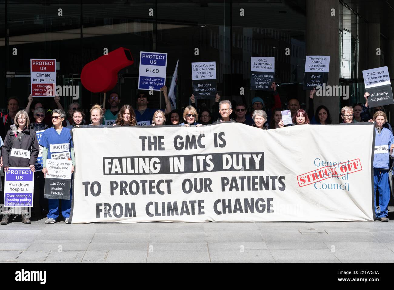 London, UK. 18 April, 2024. Doctors, health workers and patients stage a climate protest outside the General Medical Council (GMC) office in central London. They called on the GMC to recognize global heating as a health crisis, to divest funds, including pensions, from fossil fuel companies and for solidarity with GPs facing tribunals following convictions for climate peaceful protest. Credit: Ron Fassbender/Alamy Live News Stock Photo